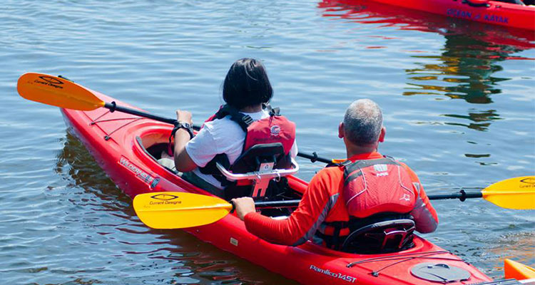 Man and woman in double red kayak